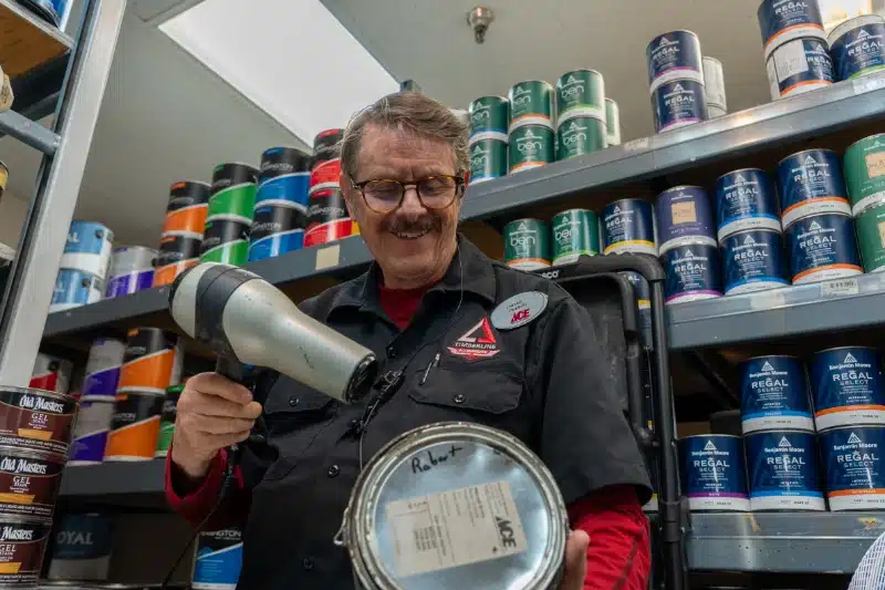 man at timerbline ace opening paint can