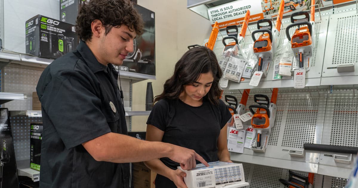 Timberline Ace Hardware employee helping a customer choose product