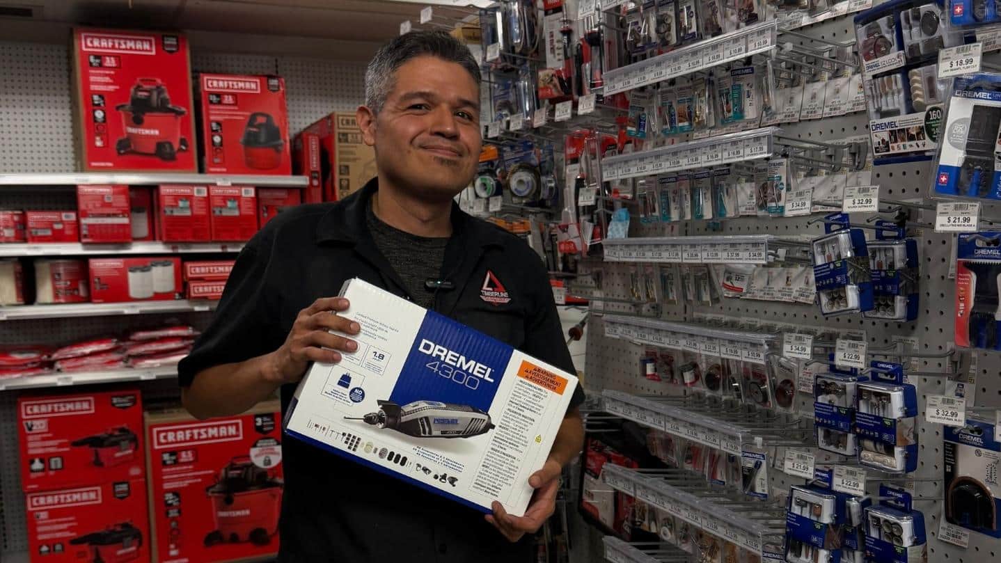 Timberline Ace team member holding a Dremel 4300 rotary tool kit for DIY and craft projects
