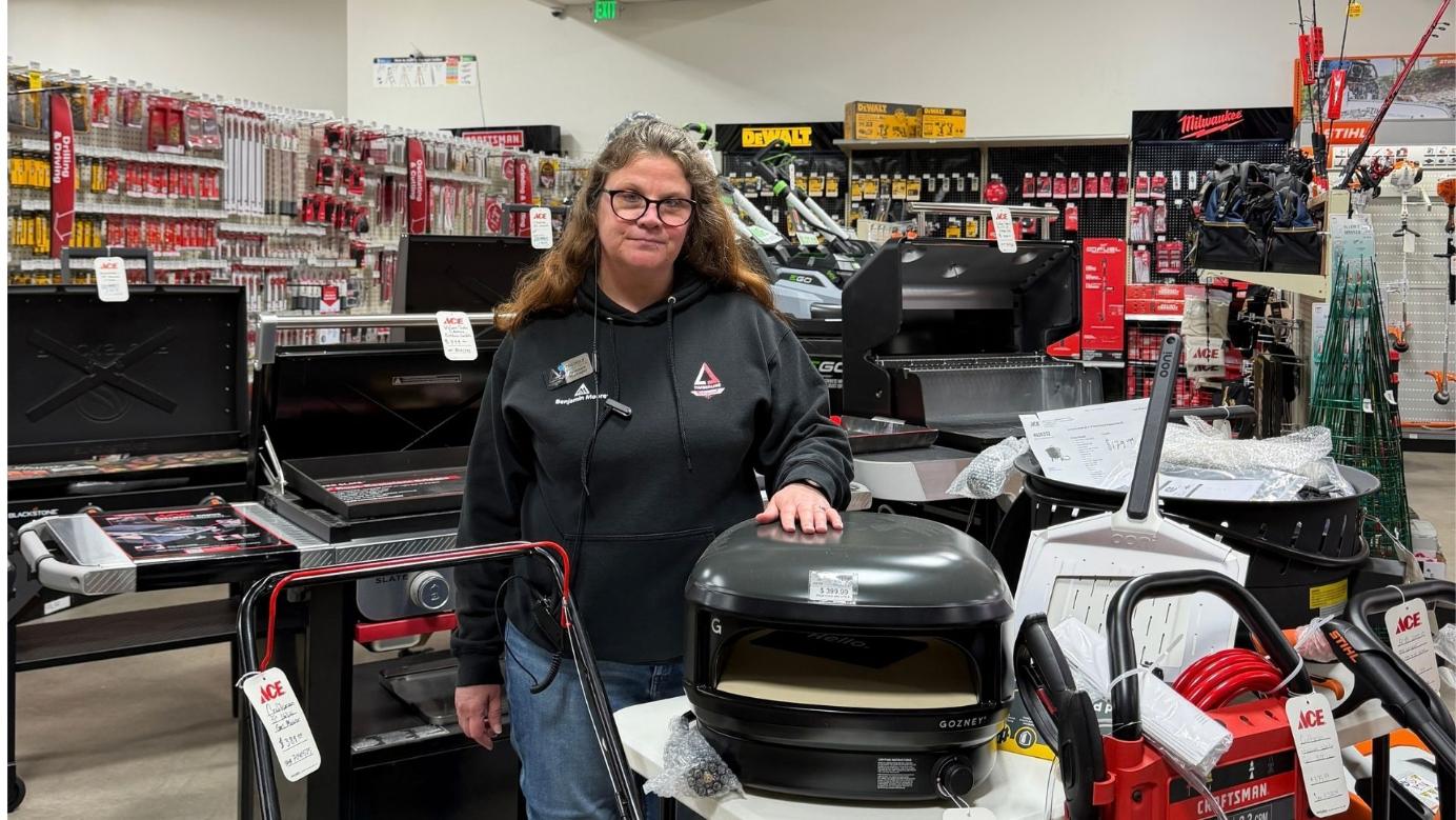 Timberline Ace team member showcasing a Gozney pizza oven as a holiday gift for grillers