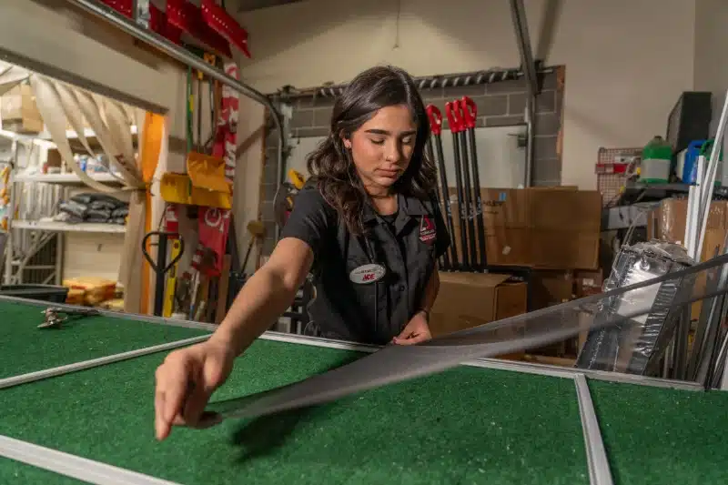 female employee repairing a screen at timberline ace