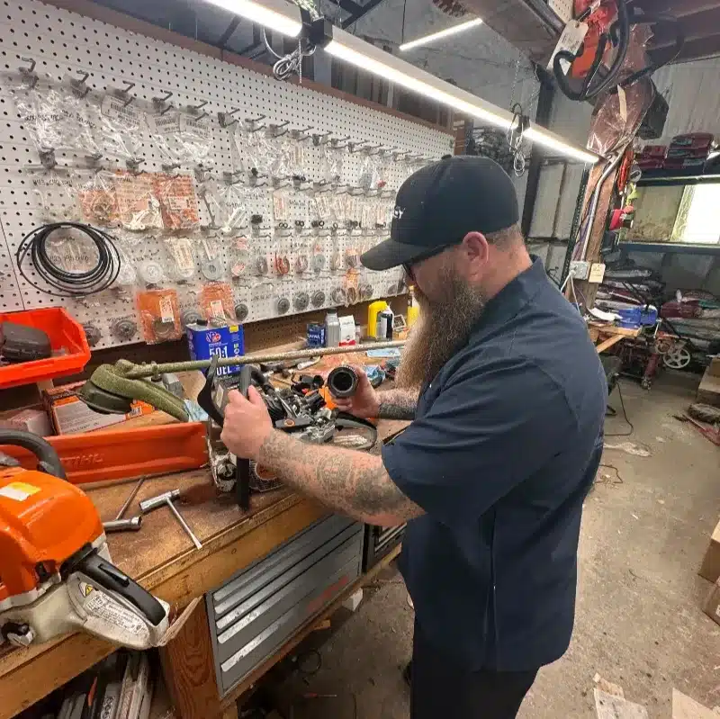 timberline ace employee working on a small engine