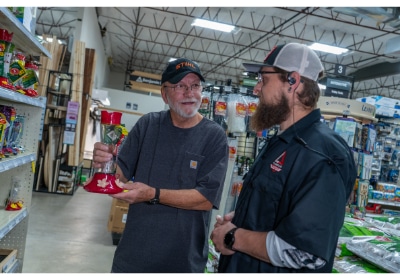 Timberline Ace Hardware of Norwood team member helping customer in the bird and lawn & garden department.