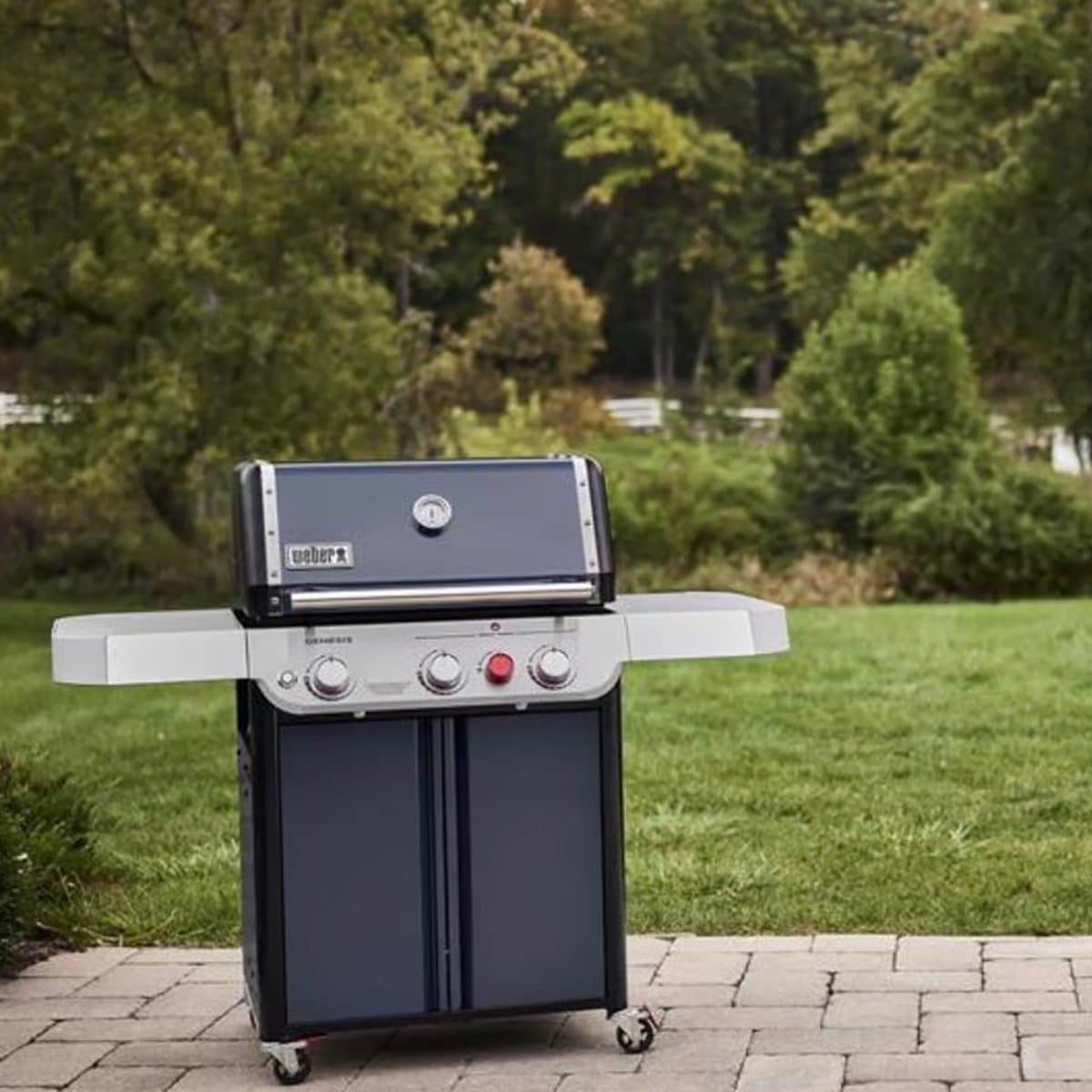 Weber propane gas grill on patio ready for backyard grilling