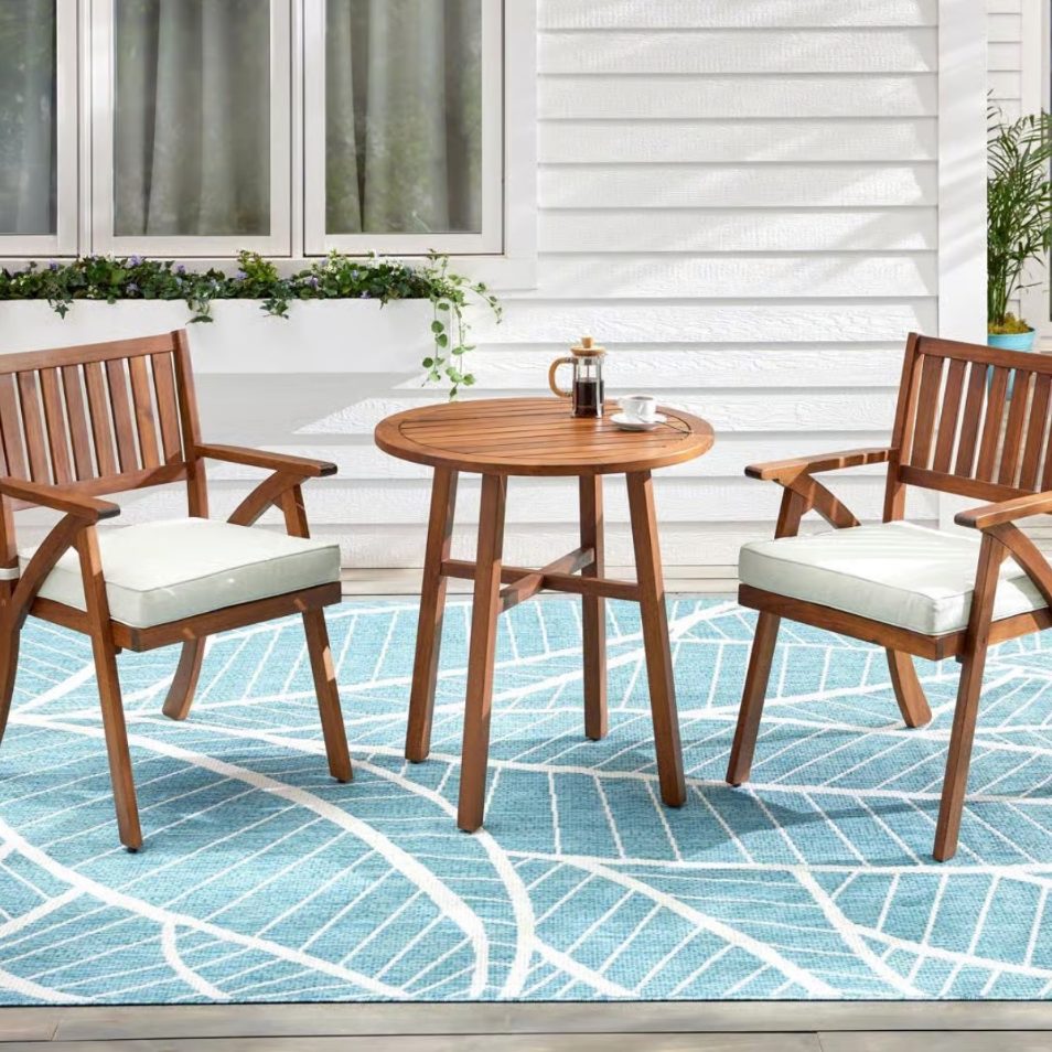 Small outdoor bistro set with two chairs and round table on patio