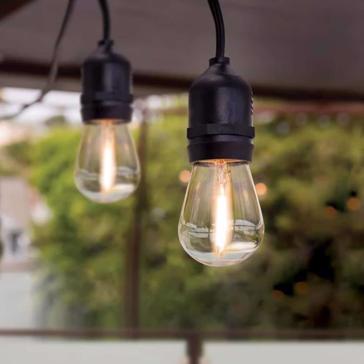 Outdoor string lights hanging on patio for backyard ambiance