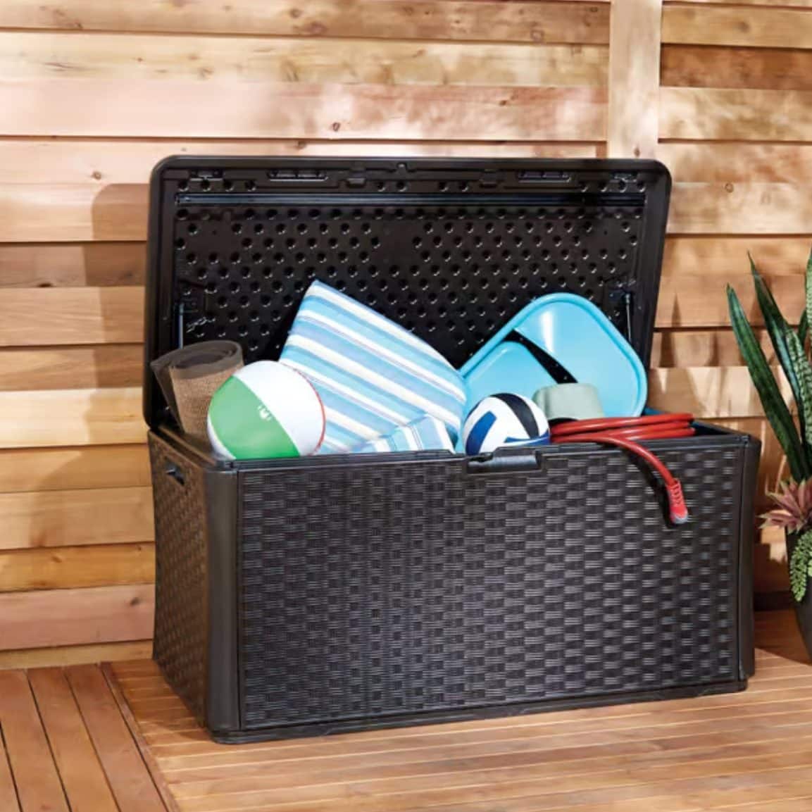 Outdoor deck storage box holding patio cushions and backyard items