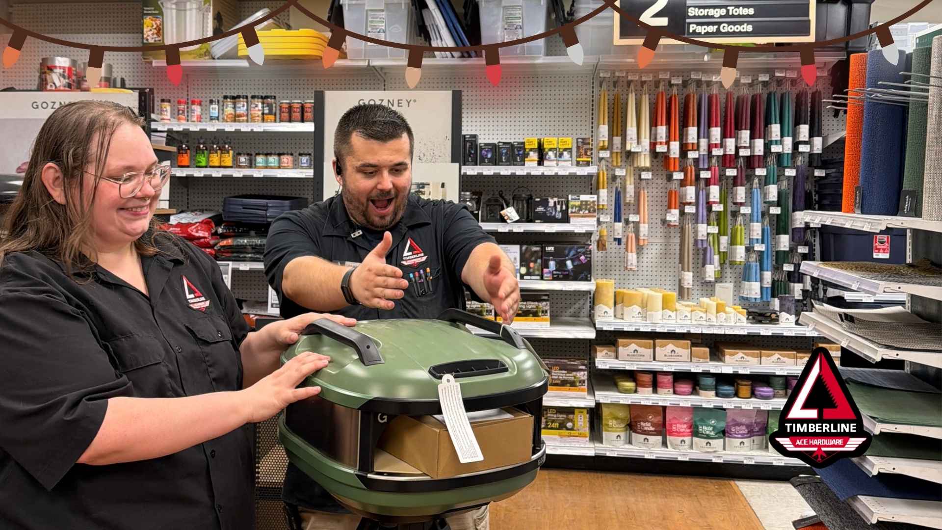 Timberline Ace team members showcasing a Gozney pizza oven for the 2026 Holiday Gift Guide